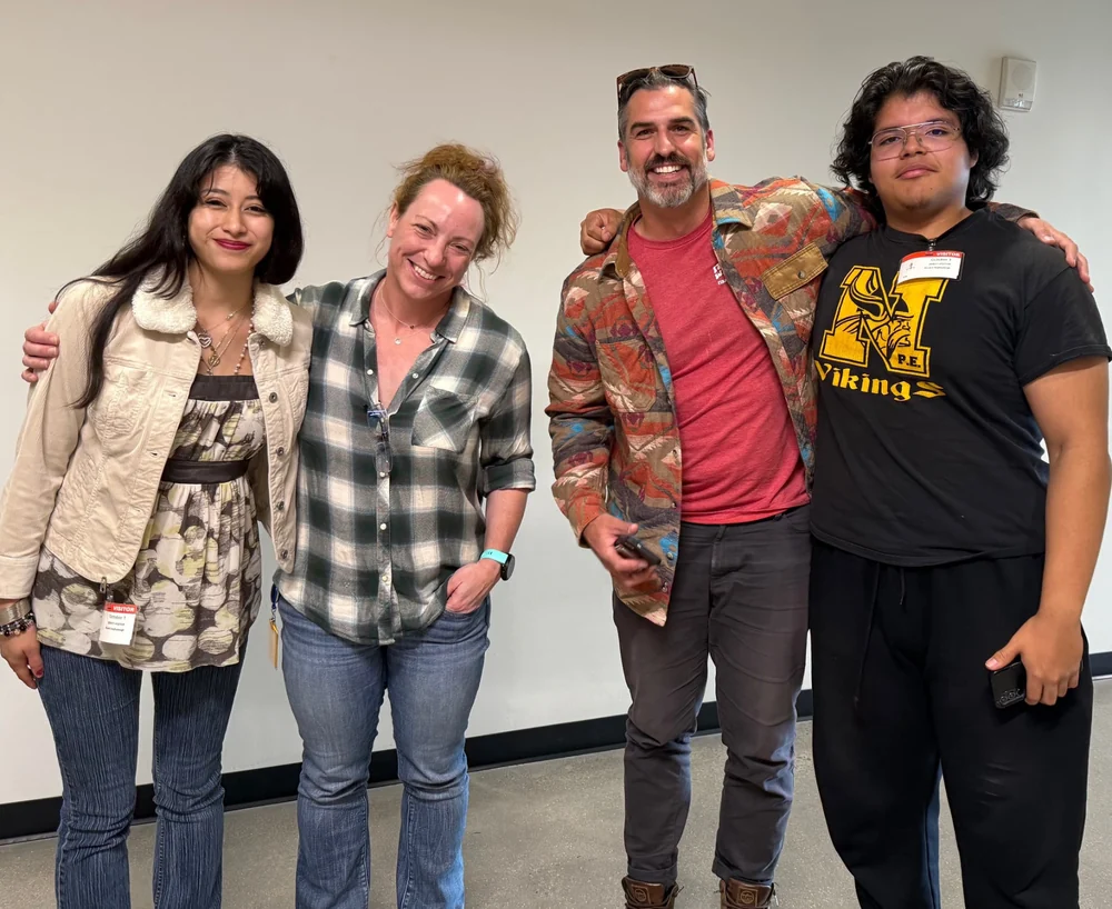 Two HighView students standing with two HighView staff members at a company visit
